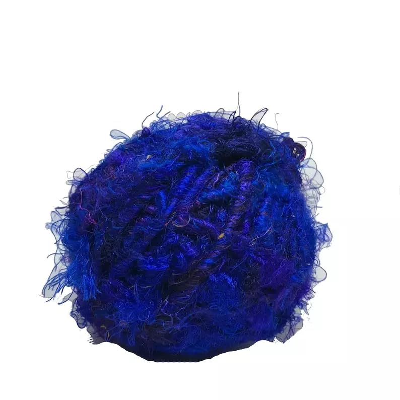 Royal Blue recycled sari silk yarn ball with textured strands on a white background